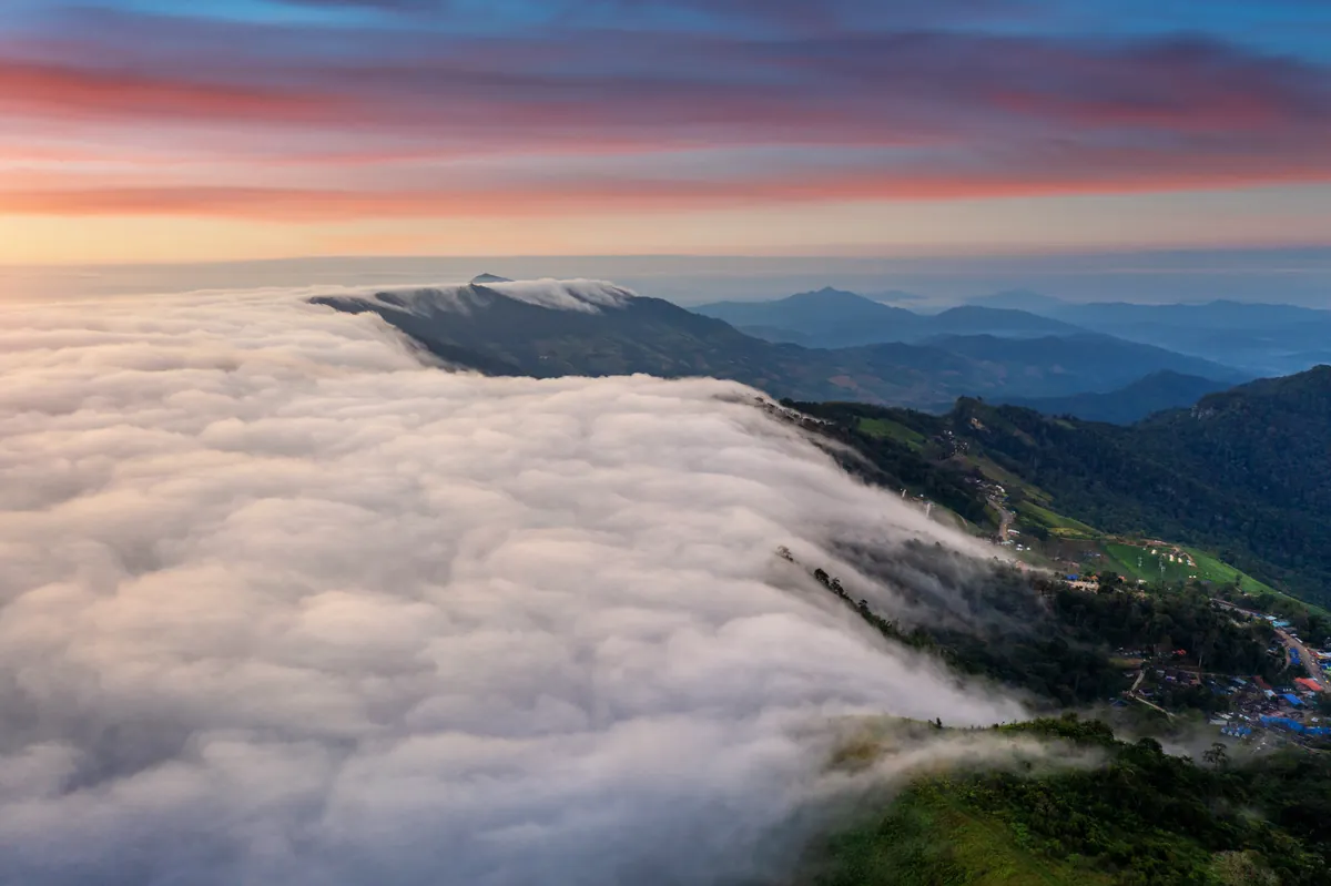 Mountain sunrise above sea of fog
